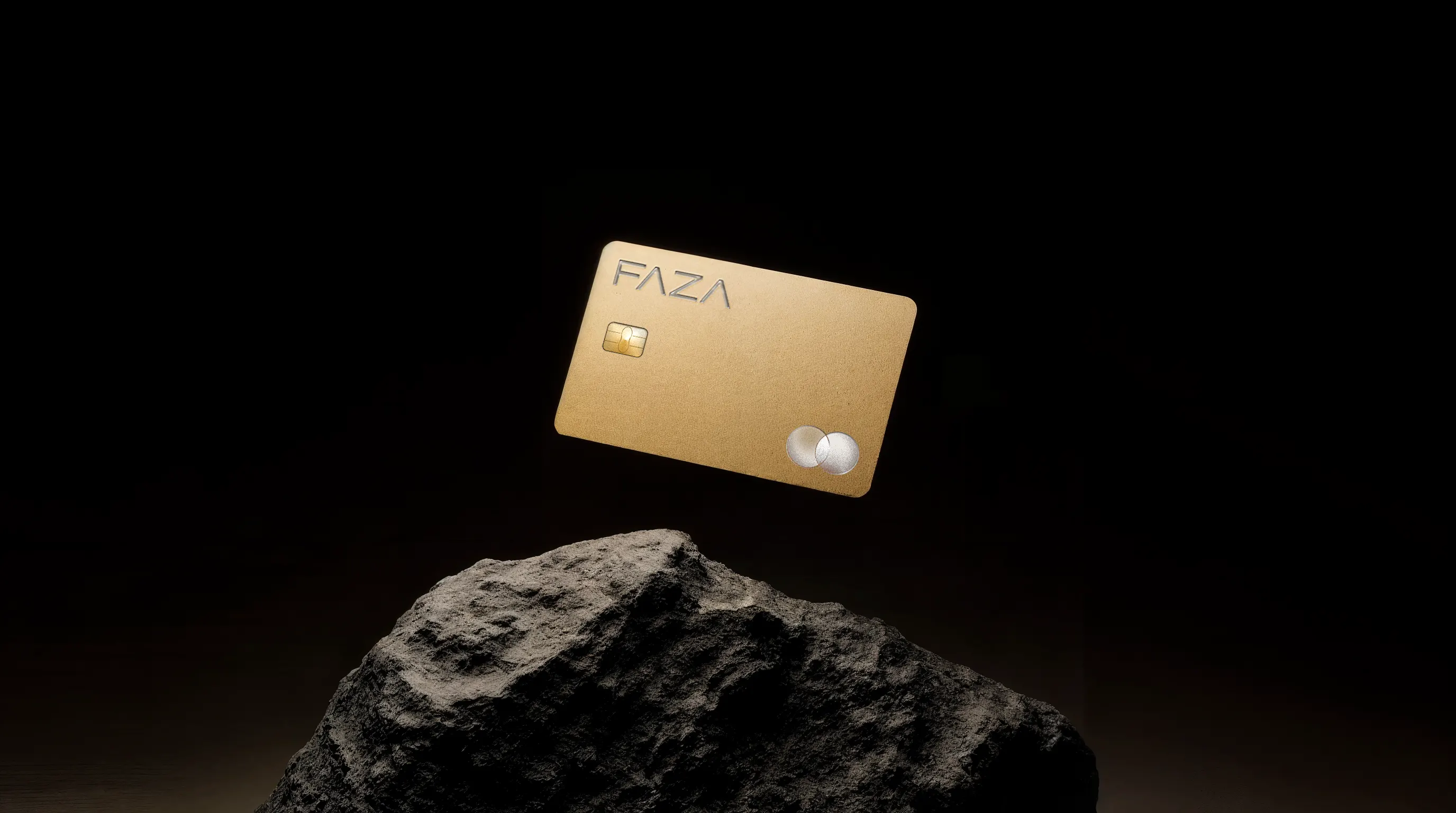 FAZA gold card standing on a dark stone - premium product shot